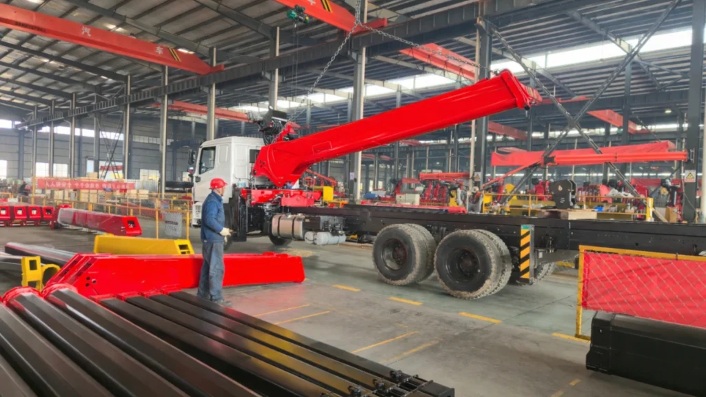 Straight boom truck-mounted crane during assembly in the factory