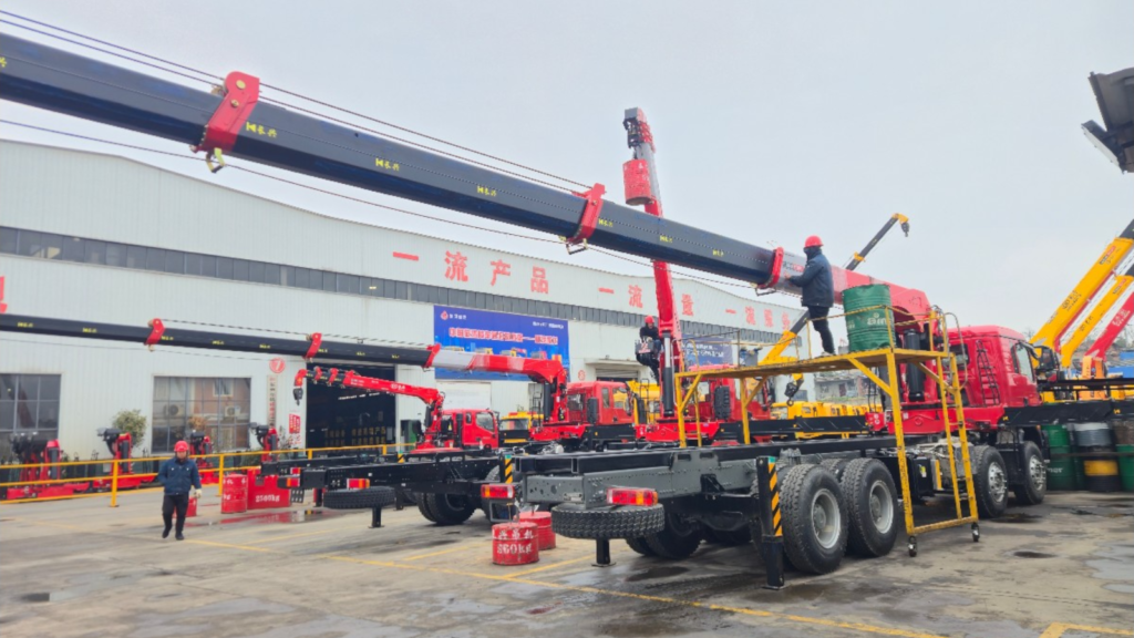 Straight boom truck-mounted crane undergoing factory testing